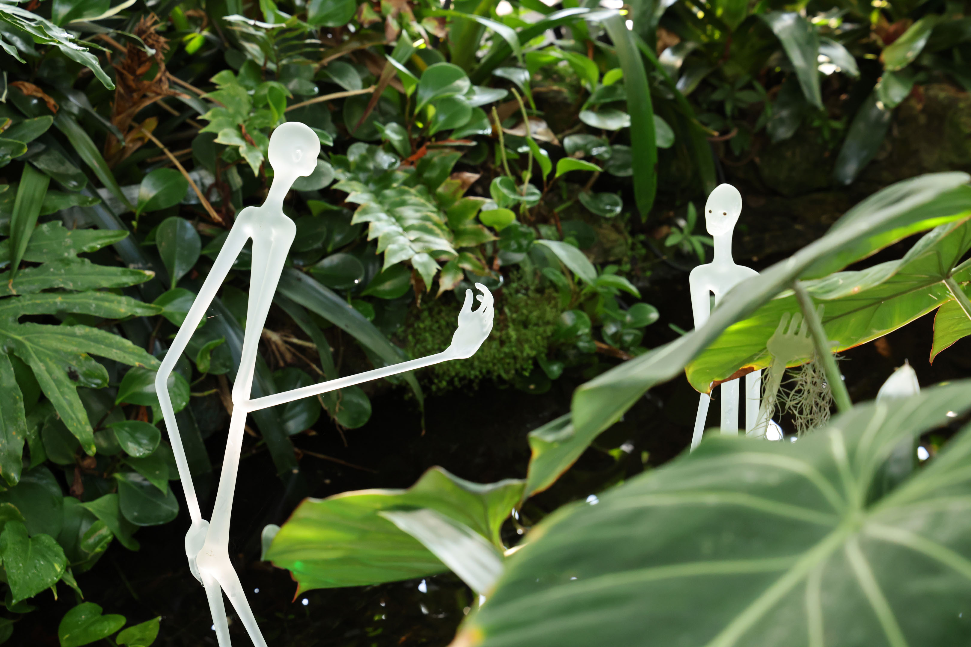 two statues among leaves