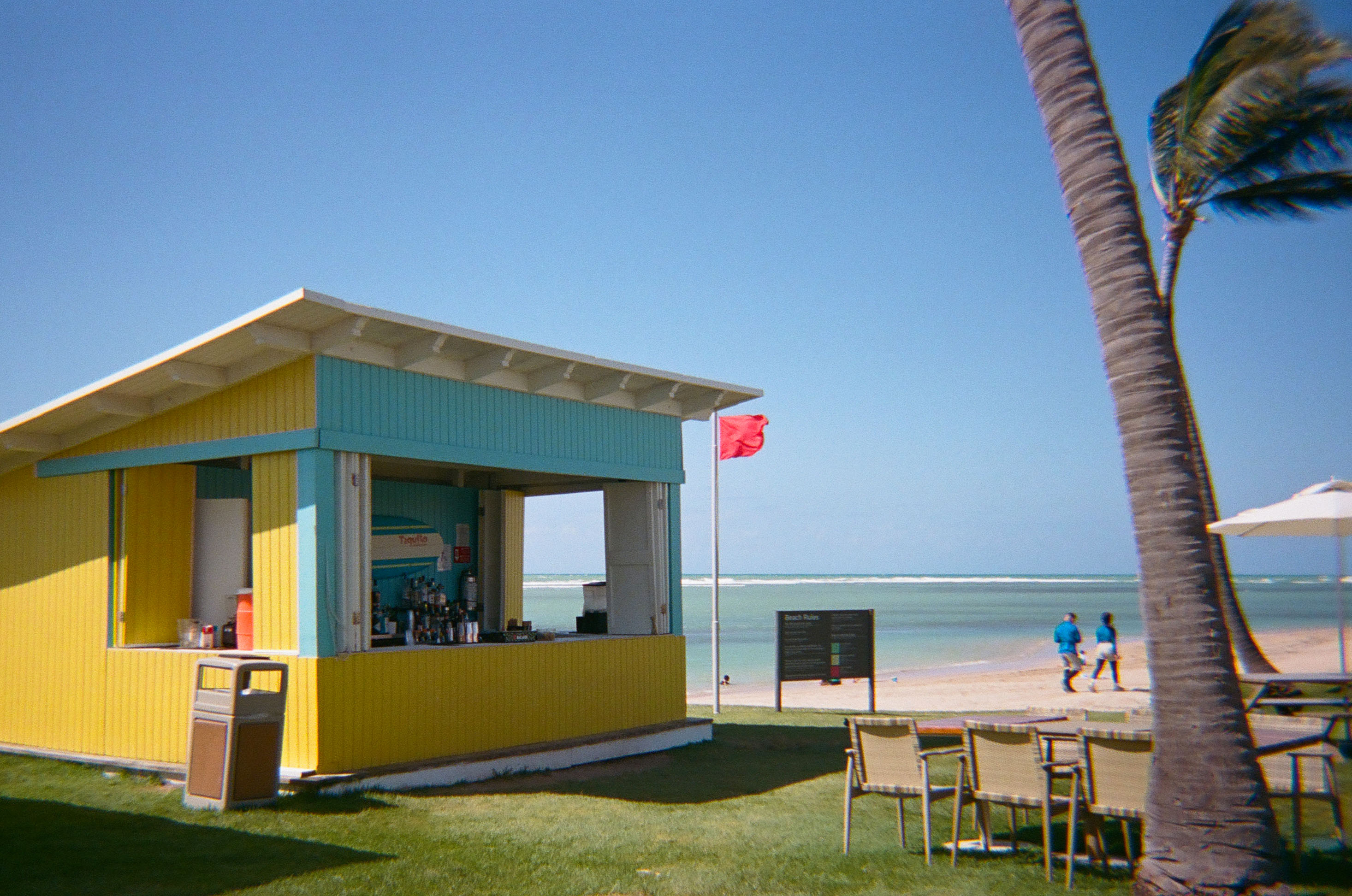a yellow and blue bar next to the beach