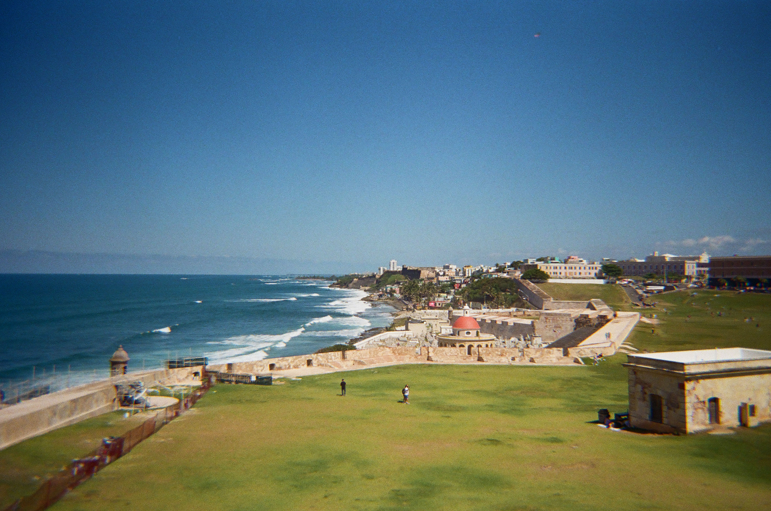 overlooking a big lawn and the city's coastline in the background